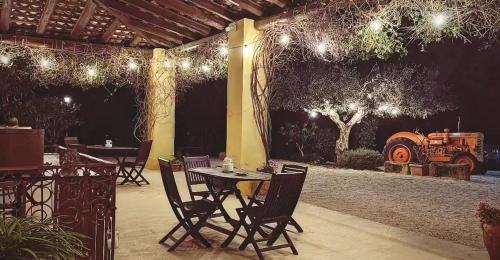 an outdoor patio with tables and chairs and lights at Agriturismo Baglio Vecchio in Castelvetrano Selinunte