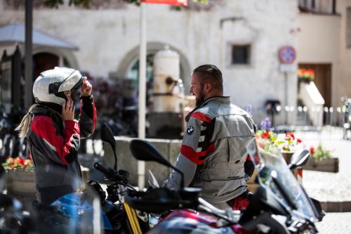 a woman taking a picture of a man on a motorcycle at Lechtaler Alpenblick Landeck - Privatzimmer & Ferienwohnung in Landeck