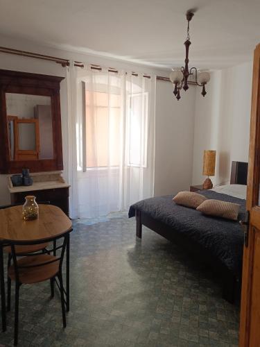 a bedroom with a bed and a table and window at ELLE in Rovinj