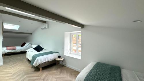a bedroom with two beds and a window at Maison LAURENTZENIA in Saint-Jean-Pied-de-Port
