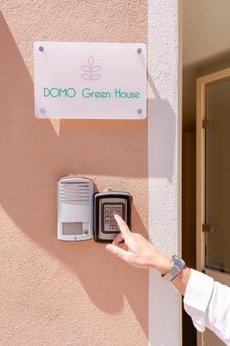 a person is pointing at a dojo green house mailbox at Domo Green House in Villasimius