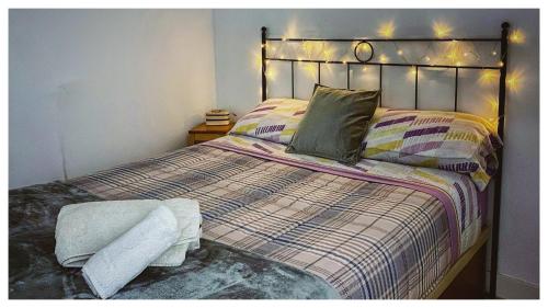 a bedroom with a large bed with lights on it at Casa Carmen con finca y piscina privada in Cea