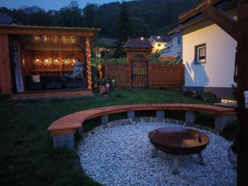a backyard with a fire pit in the yard at Ferienwohnung Elisabeth Waxweiler in Waxweiler