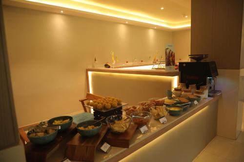 a buffet line with many bowls of food on it at Fortune Statue Of Unity, Ekta Nagar - Member ITC Hotels' Group in Kevadia