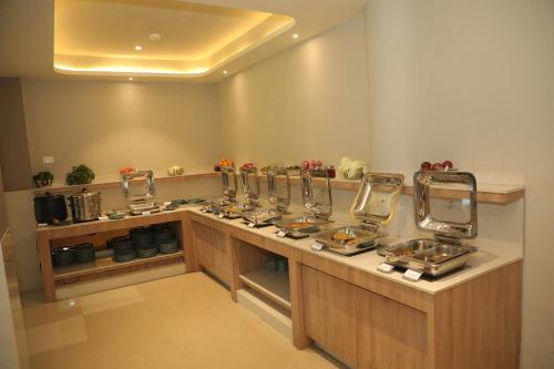 a kitchen with a counter with sinks and mirrors at Fortune Statue Of Unity, Ekta Nagar - Member ITC Hotels' Group in Kevadia