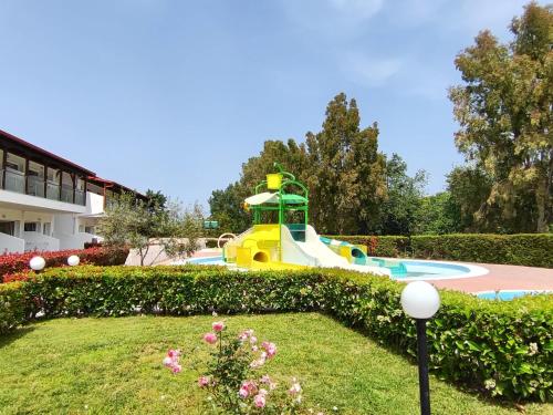 a playground in a park with a slide at Alexandros Palace in Ouranoupoli