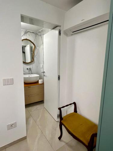 a bathroom with a sink and a toilet and a mirror at Cozy flat near the beach in Zoagli