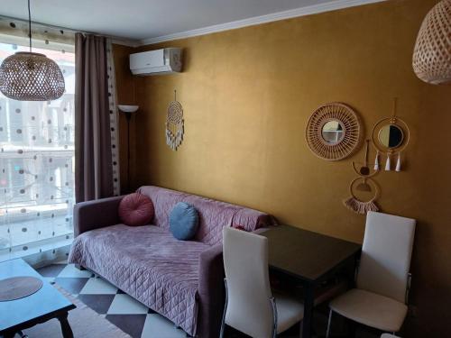 a living room with a couch and a table at Golden Hacienda in Sozopol