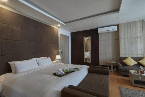 a large bedroom with a large bed and a couch at Genuss Tam Dao - Hideaway Retreats in Tam Ðảo