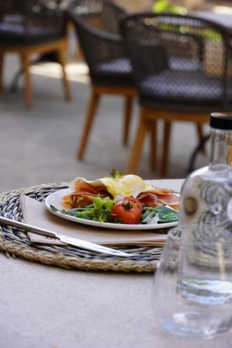 a plate of food sitting on a table at Juz de Yartan Art Hotel - Adults Only in Artá