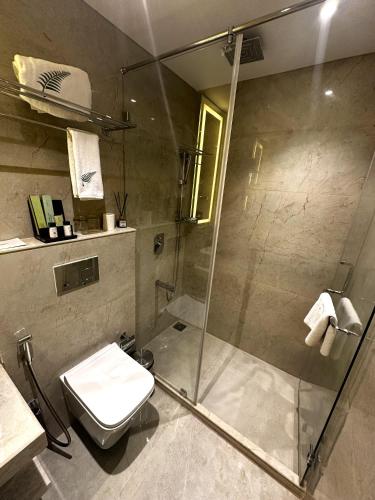 a bathroom with a shower and a toilet at The Fern Residency Ajmer in Ajmer