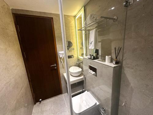 a bathroom with a sink and a toilet and a shower at The Fern Residency Ajmer in Ajmer