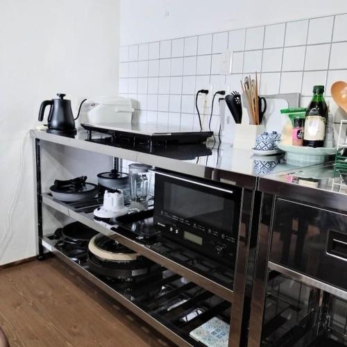 a kitchen with a stove top oven in a kitchen at vacation house WAKURA わ蔵 in Tomi