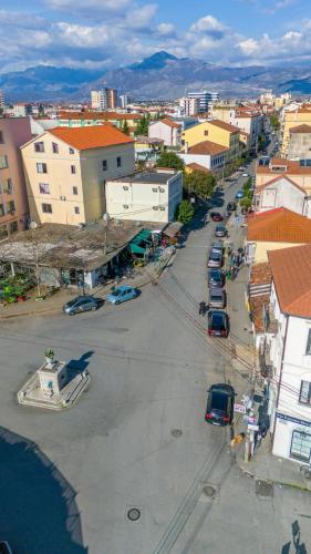 an aerial view of a city with cars parked on a street at Golden Sleep Hostel in Shkodër