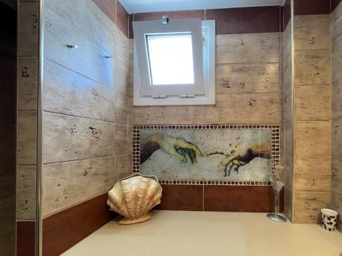 a bathroom with a painting of horses on the wall at katerina`s house in Kefalos