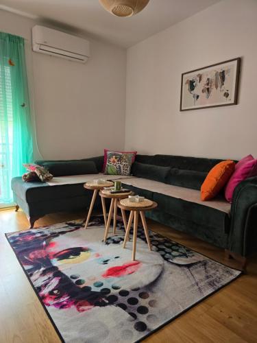 a living room with a couch and two tables at Apartman AURORA CETINJE in Cetinje