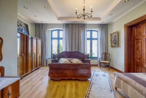 a living room with a couch and a chair at APARTAMENT & SPA Dworski Zakątek in Reda