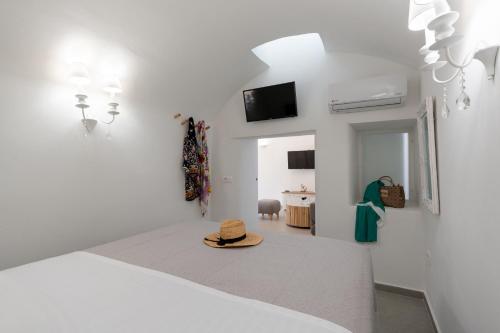 a bedroom with a bed with a hat on the floor at Euphemus Cave House in Mesaria