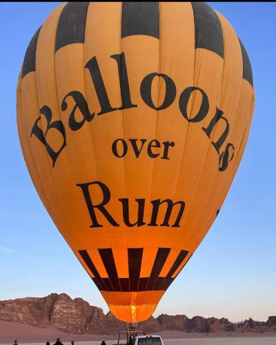 a yellow hot air balloon in the desert at Wadi Rum Desert Camp in Wadi Rum