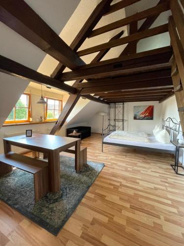 a living room with a table and a bed at CASA RUSTICA Bodensee Ferienwohnungen in Stetten