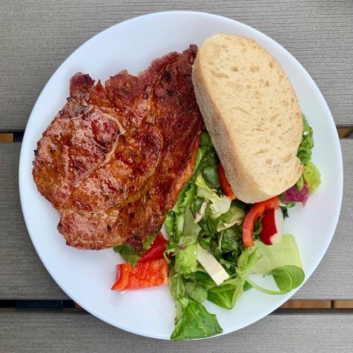 a plate with a steak and a salad and a sandwich at black well in Jablonec nad Nisou