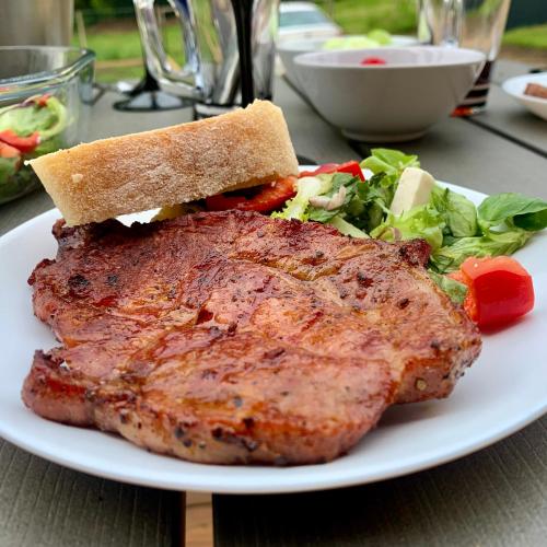a plate with a piece of meat and a salad at black well in Jablonec nad Nisou