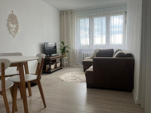 a living room with a couch and a table at Sunny View Apartament in Bytom