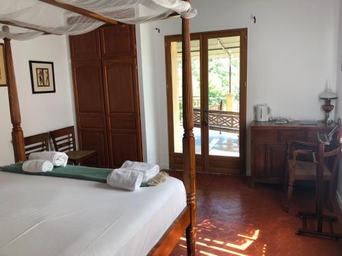 a bedroom with a bed and a door to a patio at Villa Les Cedres in Aix-en-Provence