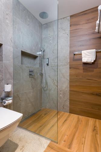 a bathroom with a shower with a glass door at IntercityHotel Bawshar Muscat in Muscat