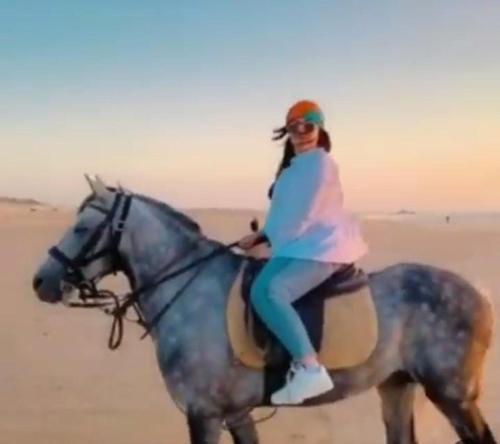 a woman riding a horse in the desert at Majorelle Family Residence Medina in Marrakech