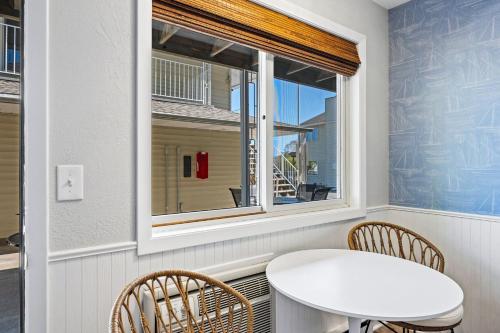 a table and chairs in a room with a window at Fresh Coast Motel in Fish Creek