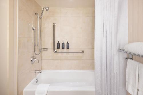 uma casa de banho com um chuveiro e uma banheira em Sheraton Vancouver Wall Centre em Vancouver