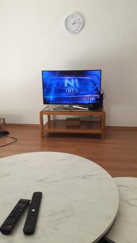 a living room with a tv and two remote controls at Veledar 2 in Čapljina