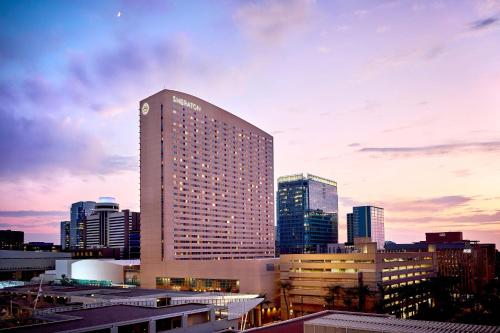 a tall building in front of a city skyline at Sheraton Phoenix Downtown in Phoenix