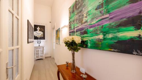a hallway with a vase of flowers on a table at Donna Fortuna in Catania