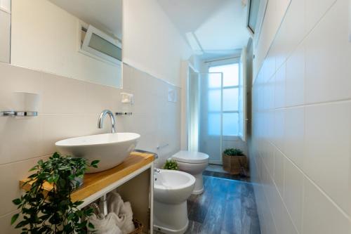 a bathroom with a sink and a toilet at Donna Fortuna in Catania