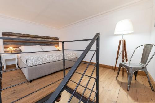 a bedroom with a bed and a desk and a chair at Donna Fortuna in Catania