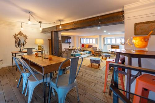 a dining room with a table and chairs and a living room at Donna Fortuna in Catania