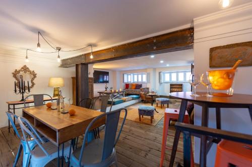 a dining room and living room with a table and chairs at Donna Fortuna in Catania