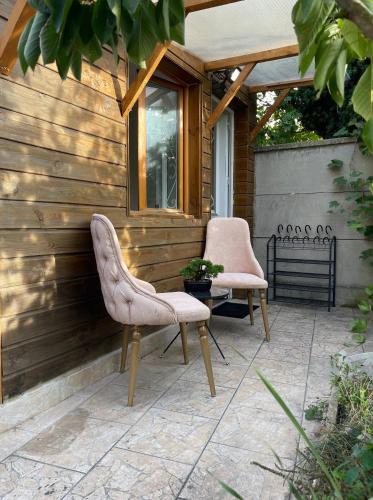 two chairs and a table on a patio at Petit Paradis Mesnil in Le Blanc-Mesnil