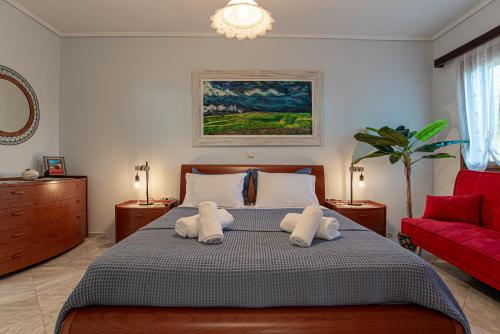 a bedroom with a bed with two towels at Feliz Apt- Breathtaking Seaview and Sunset by ΜΡS in Anavyssos