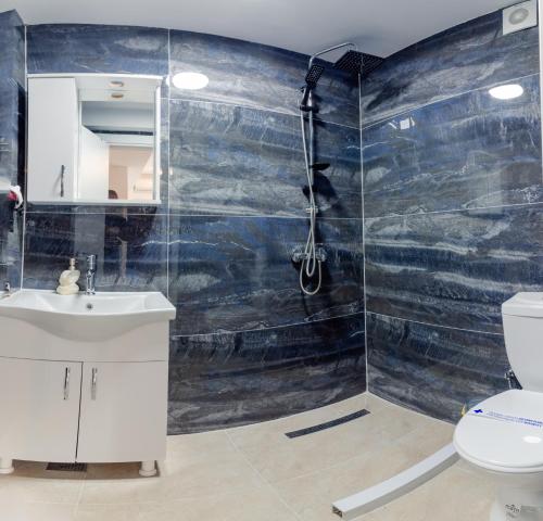 a bathroom with a shower and a toilet at Apartments BRAVO in Ohrid