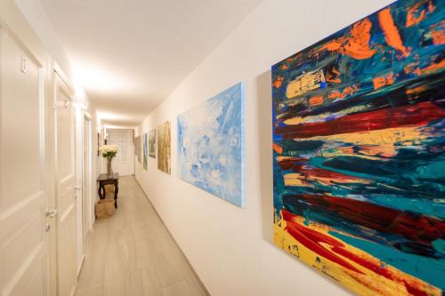 a hallway with paintings on the walls at Donna Fortuna in Catania