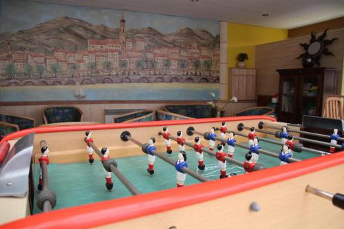 a billiard table with a group of people playing at Hotel Menton Riviera in Menton