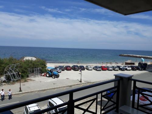 a group of cars parked in a parking lot next to the beach at Таня 10 in Pomorie
