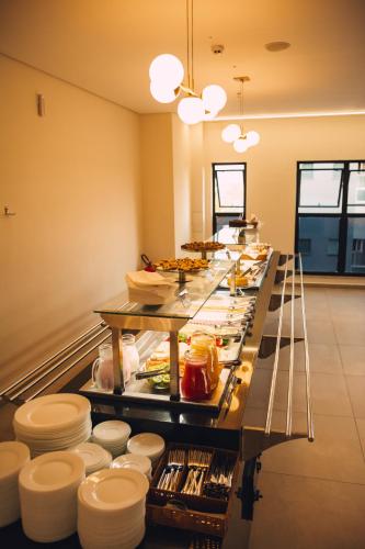 a buffet line with plates and food on it at Britto Hotel in Aparecida