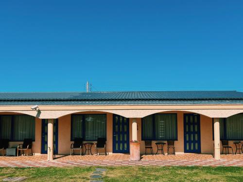 a building with chairs and tables on a patio at Ding Jia Garden Resort in Hengchun
