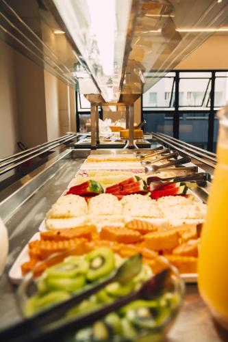 a buffet line with many different types of food at Britto Hotel in Aparecida