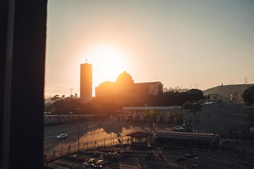 a sunset view of a city with a building at Britto Hotel in Aparecida