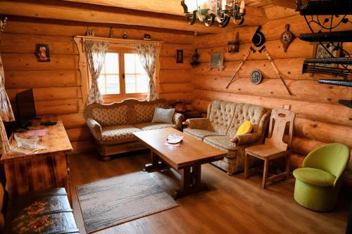 a living room with a couch and a table at Zbojnicky penzion in Oravska Jasenica